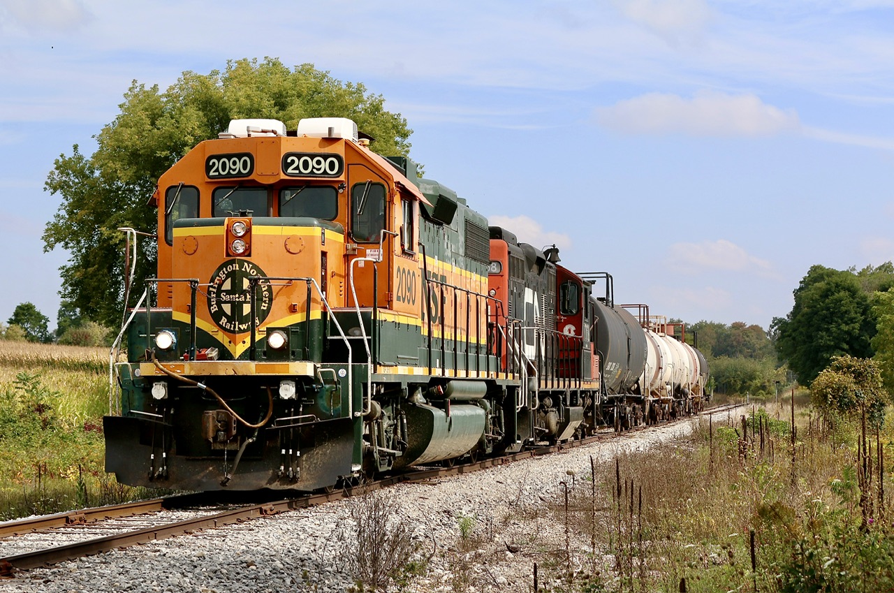 An unlikely duo in 2023 in the form of horsepower hour payback BNSF GP38-2 2090 and a CN GP9RM, are seen slowly heading down the Fergus spur with five cars for Flochem just southwest of Guelph. The  Fergus spur has definitely seen better days considering the traffic the line once generated especially within Cambridge. Today Flochem is one of only two surviving customers left on the line.
