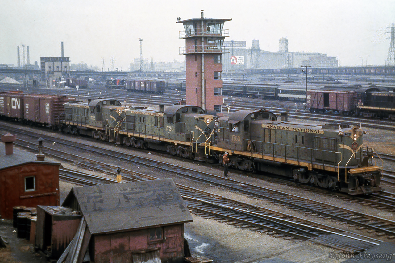 An extra freight behind three MLW RSC13s prepares to depart Bathurst Street freight yard for Guelph and Stratford.  In the background, S13 8513 switches an outside braced, wood boxcar, while a pair of RS18s sit near the coaling tower.John Freyseng Photo, Jacob Patterson Collection Slide.