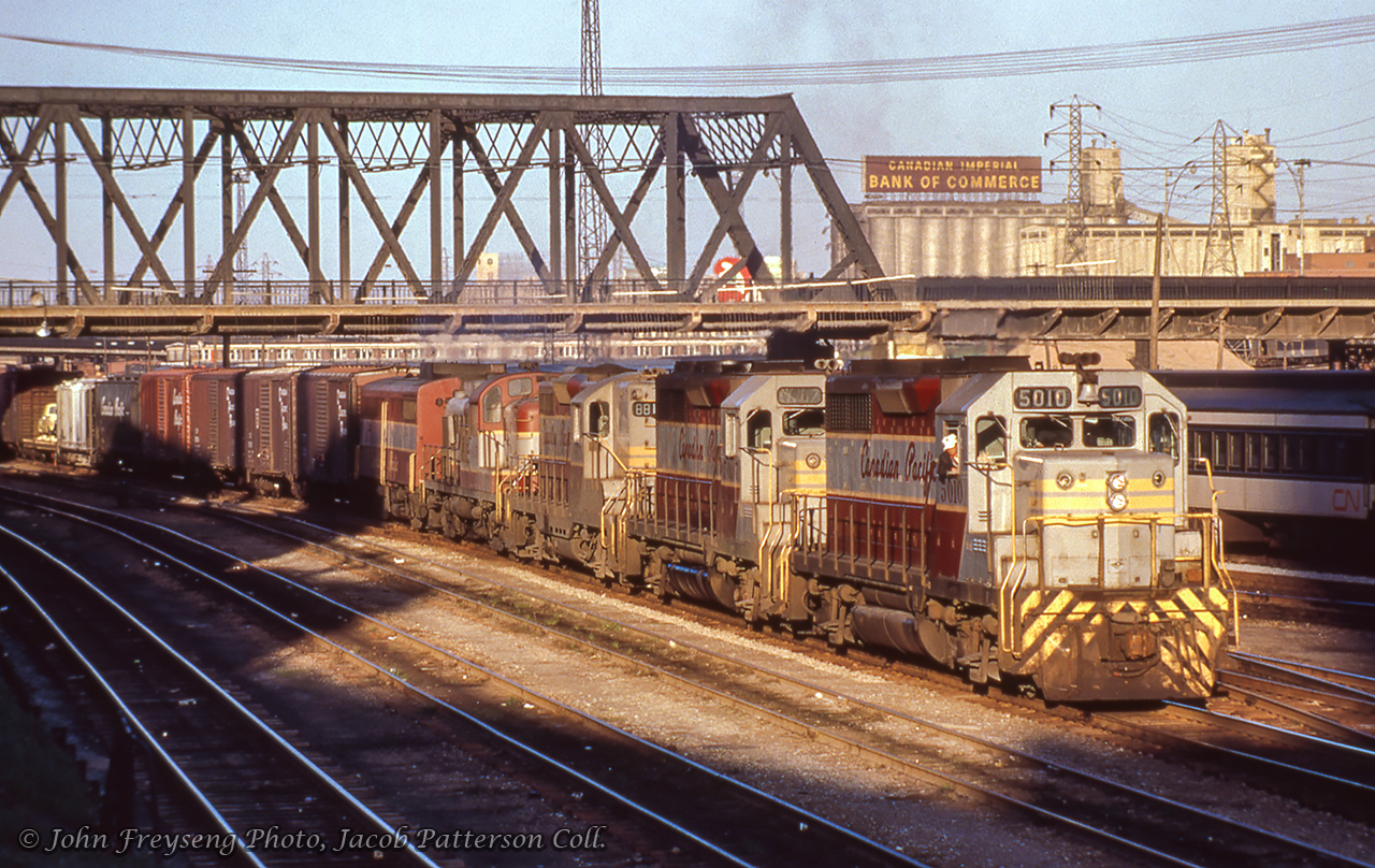 CP train 955, running Agincourt - Parkdale - Sudbury - Winnipeg - Vancouver, passes beneath Bathurst street into the evening sun.Scan and editing by Jacob Patterson.