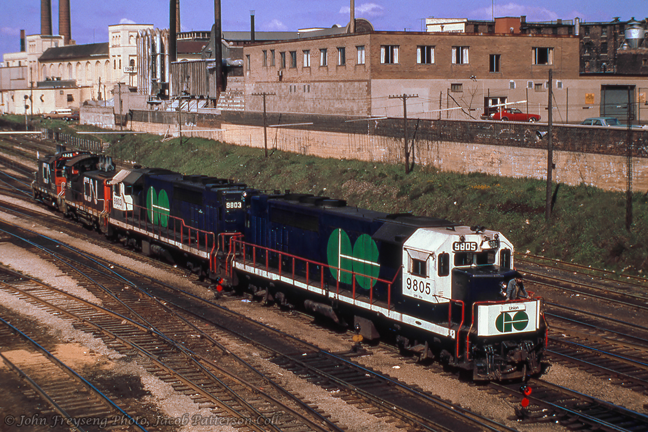A pair of SW1200RS switchers and two of GO Transit’s initial eight GP40TC diesels, originally numbered 600-607 (final renumbering 500-507 in 1975) are backing into CNR Bathurst St. freight yard to couple up to a transfer and take it to Vaughan Yard. These diesel units were basically a 3000hp GP40 built with a lengthened frame to accommodate the auxiliary engine/generator (HEP). They arrived from GMD in London several months before GO train debut between Pickering-Toronto Union-Oakville, May 23, 1967).  I first saw these at CN's Toronto Yard as seen here on January 28, 1967.John Freyseng Photo, Jacob Patterson Collection Slide.