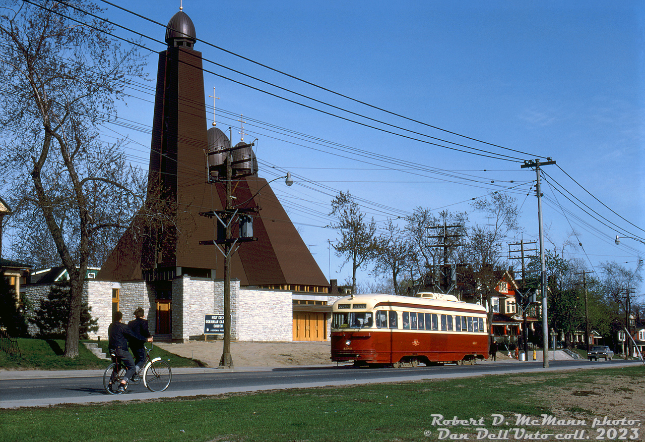 Two lads on a bicycle meet TTC PCC 4280 (A5-class car, built by CC&F in 1945), operating on an eastbound King run heading northbound up Broadview Avenue at Bain, passing by the new Holy Eucharist Ukrainian Catholic Church (completed a year earlier). The yellow card on the dash likely read "Broadview Station", as the rollerblind destination signs on older cars facing retirement may not have been updated with the new subway station names in 1966.

The end for many of the TTC's early air-electric PCC streetcars was days away: 4280 would be one of the old air-electric PCCs rendered surplus a few days later by the opening of the Bloor-Danforth extensions in 1968 (eliminating the Bloor and Danforth "shuttle" runs operated with streetcars since 1966), and subsequently end up as one of the cars sold to Alexandria, Egypt in 1968.

Robert D. McMann photo, Dan Dell'Unto collection slide.