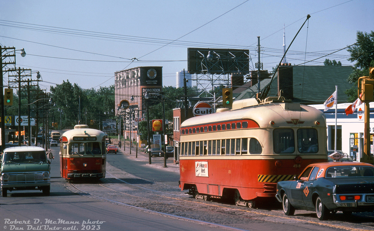 TTC PCC 4518 heads southbound on Mount Pleasant Road at Davisville Avenue, meeting sister car 4530 (both A8-class PCC's built by CC&F in 1951, Toronto's newest and last PCC streetcar order) heading northbound on the Mount Pleasant streetcar route during its final month of operation. The Dominion Coal & Wood silos in the distance mark Merton Street, and just past where the road crossed over the old Toronto Beltline Railway (by then a CN spur serving the silos and TTC's Davisville Yard). The top of the CN Tower and First Canadian Place tower mark downtown Toronto as a distant but nearby place, and an old orange and black taxi (Beck?) completes the scene.

The Mount Pleasant leg of the St. Clair streetcar was spun off into its own route east of St. Clair subway station for a year during 1975-76, before being discontinued and replaced by trolleybuses. The final streetcar that operated on Mount Pleasant was Peter Witt 2766, on a special all-night fantrip charter, during the wee hours of July 25th 1976.

Robert D. McMann photo, Dan Dell'Unto collection slide.