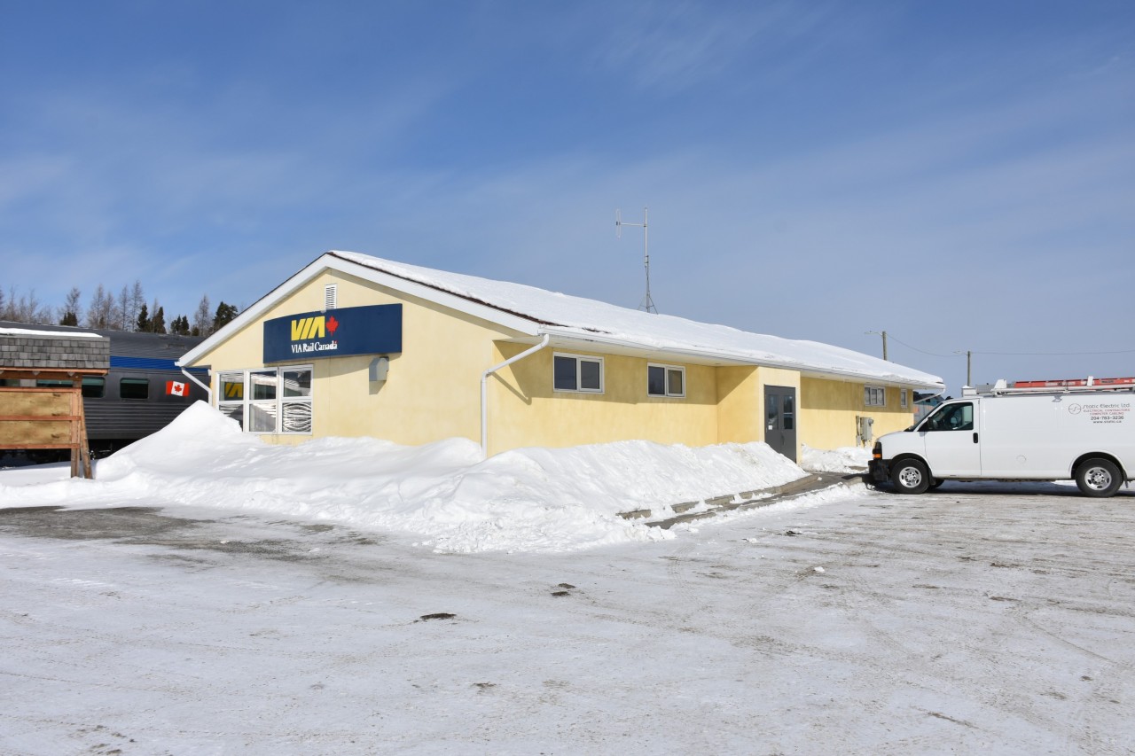 VIA 693 The Hudson Bay is parked on the station track in front of the brightly painted Thompson, MB station on this beautiful March 13, 2023 day. 
Two days later on the return trip from Churchill, the weather would be completely different with over a foot of fresh snow, and the drift at the end of the station as high as the VIA Rail Canada sign!