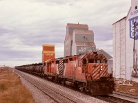 From Alyth yard in Calgary, CP ran a Princess Turn eastward 75.7 miles on the Brooks sub. mainline to Bassano then eastward 41.7 miles on the Bassano sub. to an oil loadout at Princess.  On Wednesday 1974-10-02, that job was running as timetable train No. 96 with a pair of GP35s, 5004 and 5014, as it passed milepost 125 near the grain elevators at Gleichen, with 27.2 miles to reach the junction at Bassano.

<p>In my ignorance, assuming a turbocharged GM was an SD40, those similar-sounding GP35s were entered into my notebook as 5504 and 5514, with that error not corrected until I got my slides back from that trip!  If only I had known those units would be my exasperating work when they were assigned to CP’s (Port) Coquitlam locomotive facility ten years hence.