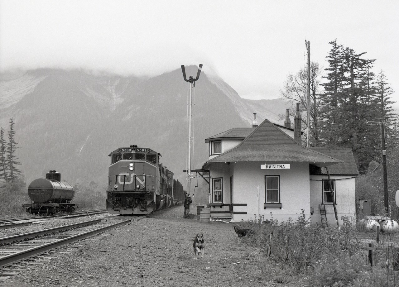 On CN’s westernmost subdivision, the Skeena between Terrace and Prince Rupert, the halfway point of Kwinitsa (mileage 48.2 from Terrace and 46.4 to Prince Rupert) was a vital communications point before CTC.  On weekdays, a regular Terrace Turn, running as No. 892 eastward from Prince Rupert, was operated to handle logs from Terrace to a pulp mill at Watson Island, and this photo shows the empties eastward behind CN 5589 + 5593 on Tuesday 1981-10-06 at 1159 PDT, with the depot operator providing a roll-by, and his dog ensuring a clear passage (and just missing my camera tripod as it zoomed past).

That Grand Trunk Pacific origin depot has been saved, now relocated to the waterfront in Prince Rupert as the Kwinitsa Railway Station Museum.
