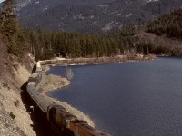 South of Seton and Anderson Lakes on the run from Lillooet, the British Columbia Railway also ran along the west side of Gates Lake near Birken, illustrated here by BCOL 718 + 701 on Thursday 1990-04-05, with Mounts Nequatque and Marriott supervising.