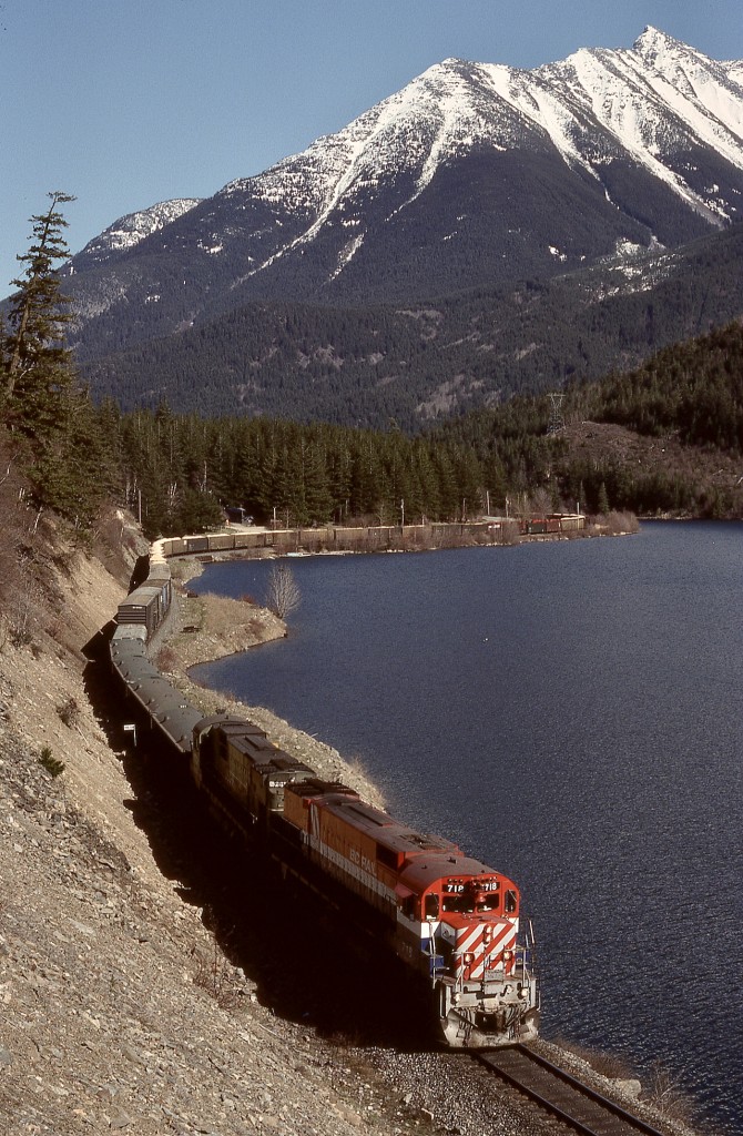 South of Seton and Anderson Lakes on the run from Lillooet, the British Columbia Railway also ran along the west side of Gates Lake near Birken, illustrated here by BCOL 718 + 701 on Thursday 1990-04-05, with Mounts Nequatque and Marriott supervising.