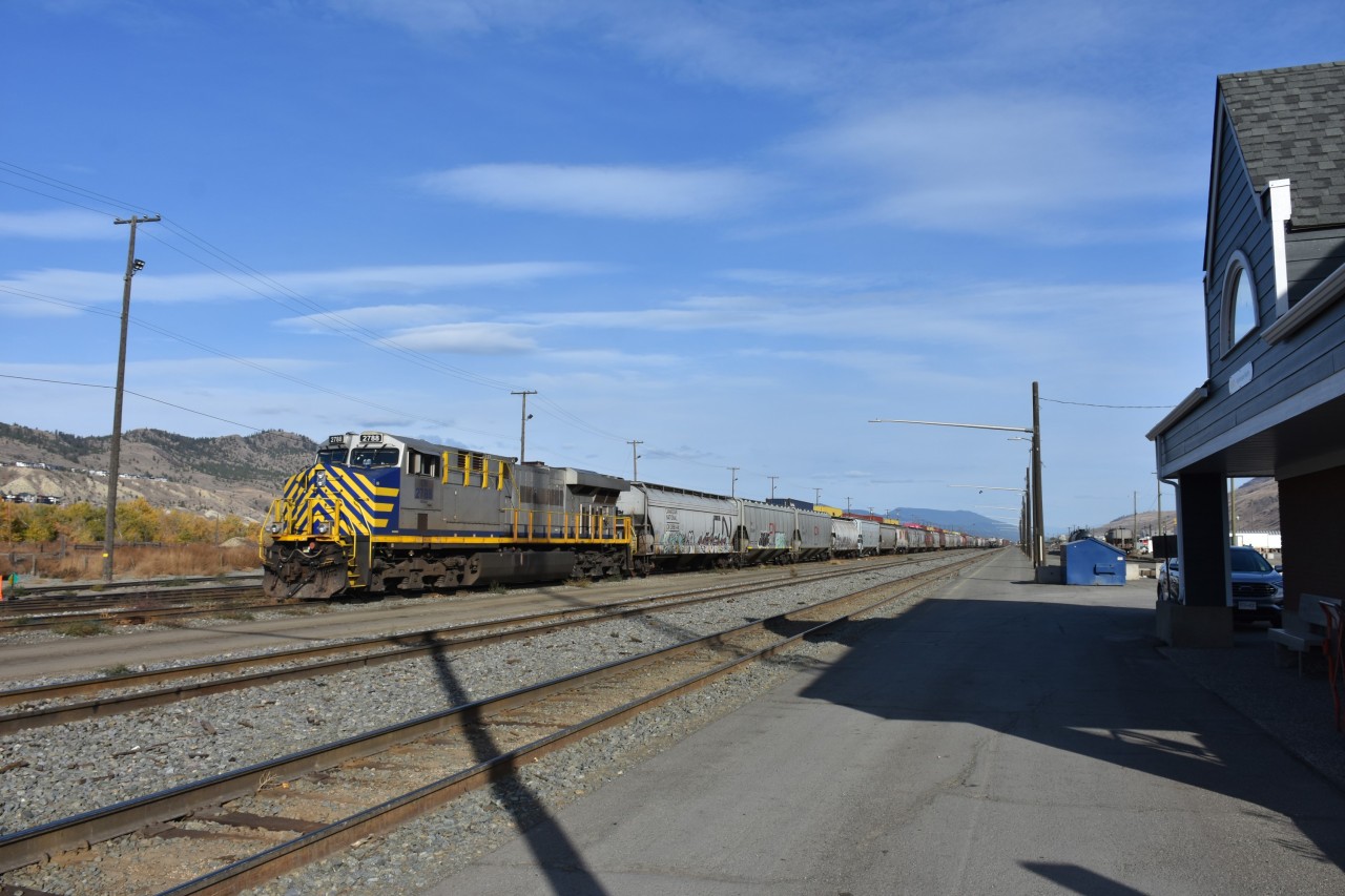 Trains and grains.  
CN 2788 ES44AC with a yard long string of grain hoppers sits idle in front of the Kamloops North VIA Rail station at Kamloops, BC on a very pleasant October 26, 2023 morning.