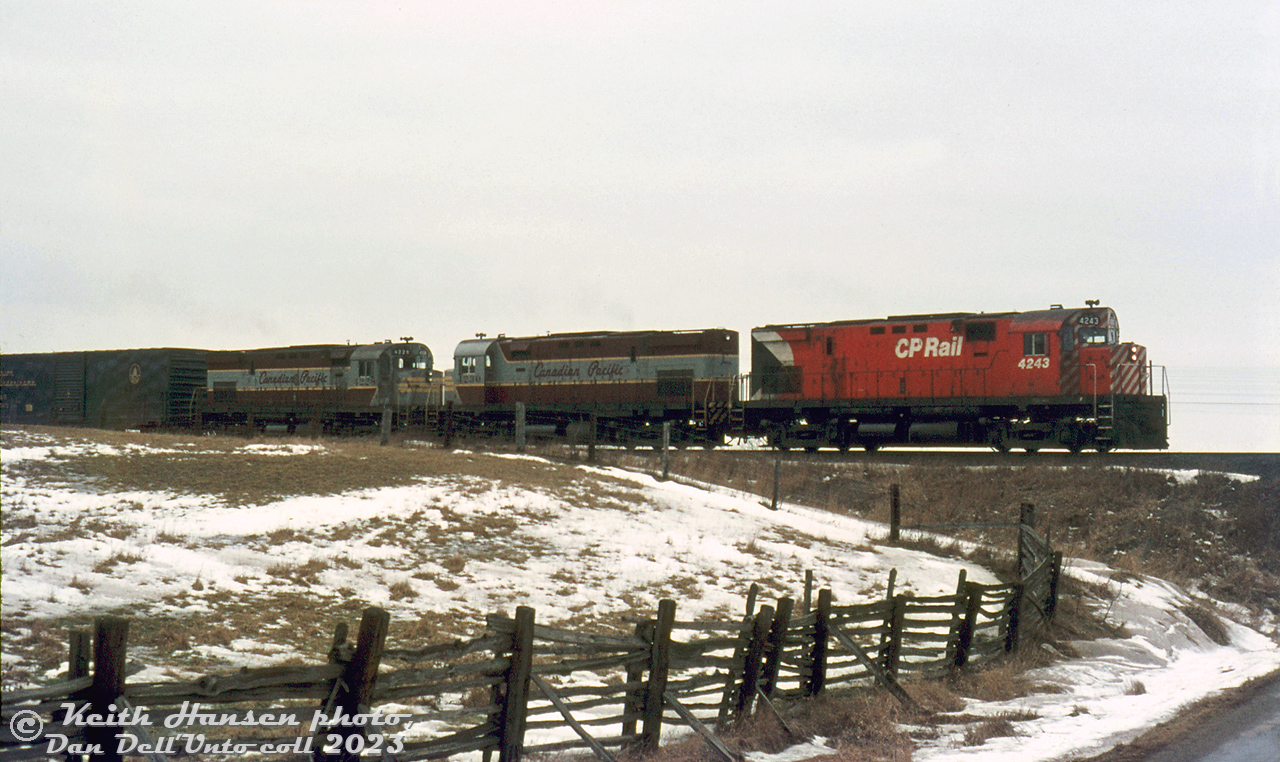 Three MLW 4-axle Centuries handle this CP freight past farmer's fields just east of Bowmanville: recently repainted CP C424 4243 leads maroon and grey sister units 4230 and 4228 on a gloomy winter day. Part of CP's first wave of second-generation Diesel Road Freight (DRF-class) locomotives purchased in the mid-60's, the 2400-horsepower C424 fleet (4200-4250) were delivered in the maroon and grey "Script" livery, and were some of the first units to see the Action Red "Multimark" paint after it was introduced.

Keith Hansen photo, Dan Dell'Unto collection slide.
