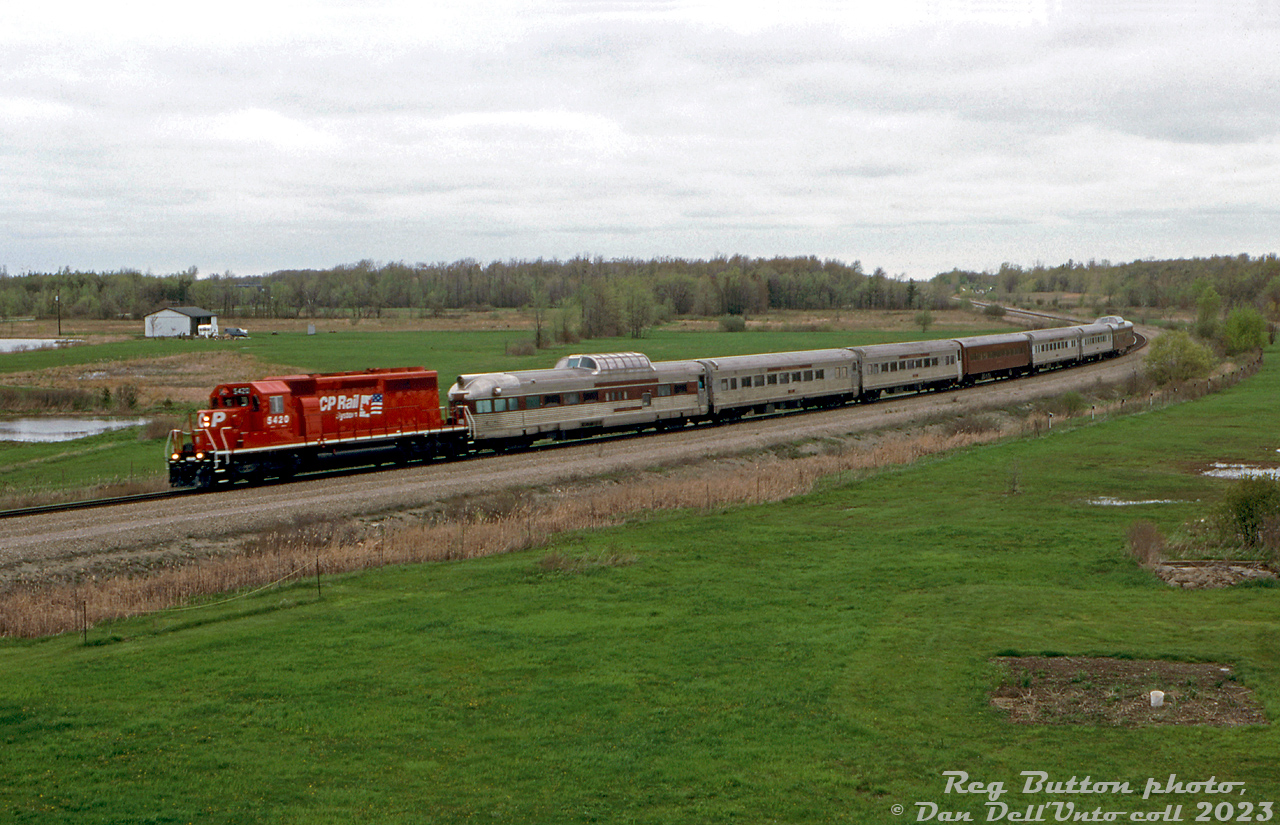 This short "passenger extra" was apparently a New York, Susquehanna and Western (NYS&W) passenger train that crossed into Canada from the US via the old MCRR/CASO bridge. The 7-car consist (complete with domes!) is seen here rolling through the curve at Brookfield on the approach to the Townline Tunnel, soon to dip under the Welland Canal. CP SD40-2 5420, one of CP's secondhand KCS units repainted in fresh "CP Rail System" paint, does the honors.

Reg Button photo, Dan Dell'Unto collection slide.