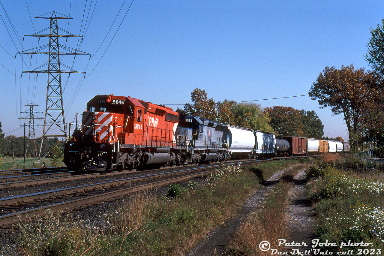 CP SD40-2 5846 and MKCX SD45 9523 lean into the curve at Lambton Mills as they leave the West Toronto area with train #511, westbound on the Galt Subdivision in the afternoon. MKCX 9523 was one of locomotive rebuilder Morrison Knudson's many lease units, in this case a former CSX unit still in CSX paint (originally built for the Seaboard Coast Line, and eventually ending up as Wisconsin Central 6636).

This location at Lambton Mills also has significance in that it was where the old Toronto Suburban Railway interurban line from West Toronto to Guelph (operations discontinued in 1931) ducked underneath CP's Galt Sub, before continuing west and crossing the Humber River on a separate railway bridge.

Peter Jobe photo, Dan Dell'Unto collection slide.