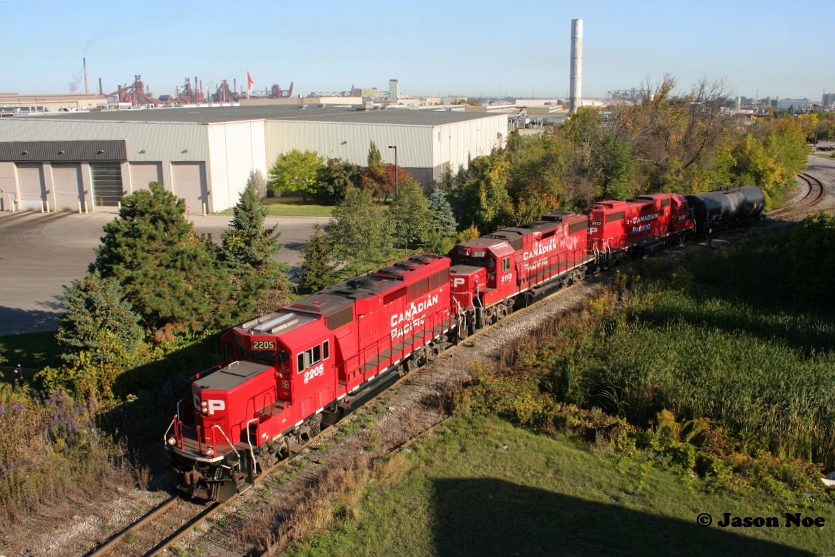 During an early fall morning CP TH41 with 2205, 3113 and 3033 is viewed with one tanker after departing possibly Parkland in Hamilton, Ontario’s rich industrial core.