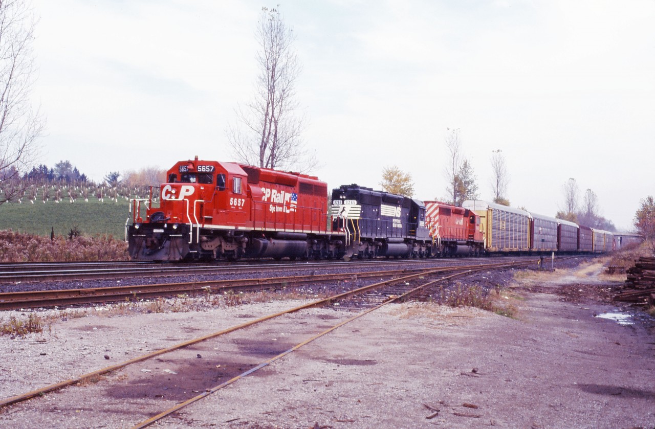 Three SD40-2s (CP 5757, NS 3265, and CP 5663) lead six auto racks and an N&W van on an over-powered NS train 327 in the fall of 1996. At the time, NS was leasing CP power for trains 327 and 328--although such trains normally were cabooseless!