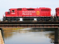 In April of this year both Canadian Pacific and Kansas City Southern came together to form CPKC. Over half a year later and locomotives are still being repainted in Canadian Pacific colors with the beaver shield logo. 
<br>
Here, the crew of CPKC H70 have the best view in the house as they pause over the Grand River in Kitchener, Ontario on the Waterloo Subdivision. The consist included CP 3024 and 2207, with GP38-2 3024 having recently been repainted in a fresh coat of red at the Progress Rail facility in Mayfield, Kentucky. 
