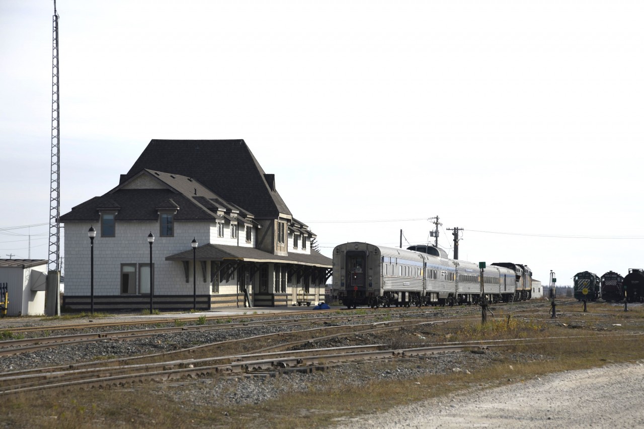 VIA 693 The Hudson Bay in Churchill, MB.  
Arriving earlier in the day at 09:30, VIA 693's consist gets cleaned, serviced, fueled, and otherwise prepared for its south bound return journey as VIA 692 at 19:30 this same evening. 
Looks like a high load of baggage or some other piece of equipment has knocked the station name sign from the north corner of the building overhang. 
The station track has been completely rebuilt since my visit there in August of 2022. New ties, rail, ballast and surfacing has made quite a difference. :-) 
What a great place to visit!!!