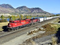 A recently rebuilt CP 7028 leads a westbound grain past the signals at Pritchard east.