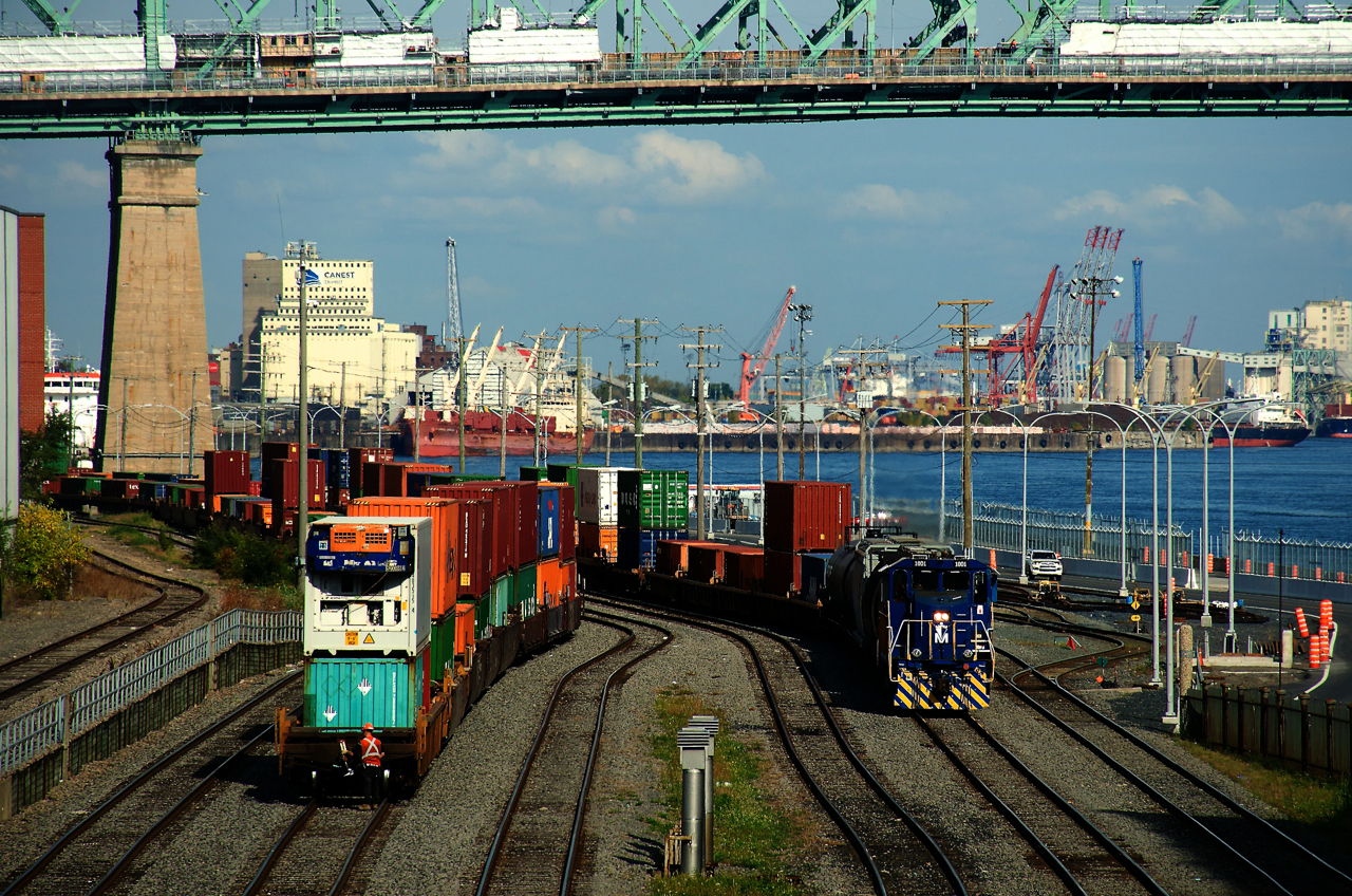 POM 1001 is about to shove cars in the Port of Montreal as an end of train device gets added to stacks at left.