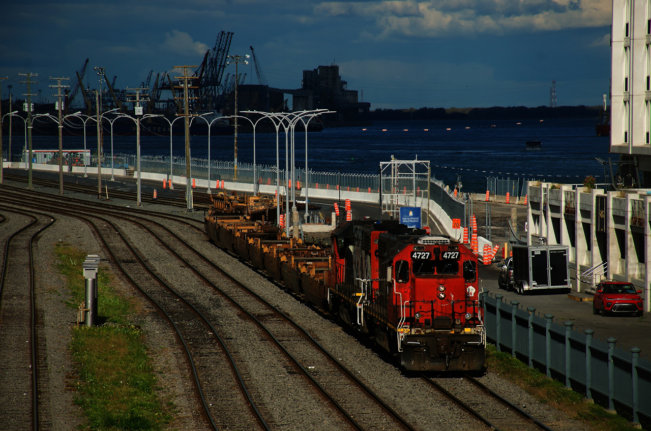 A brief period of sunshine illuminates CN 500 as it leaves the Port of Montreal with a short train of baretables. Power is CN 4727 & CN 4712.