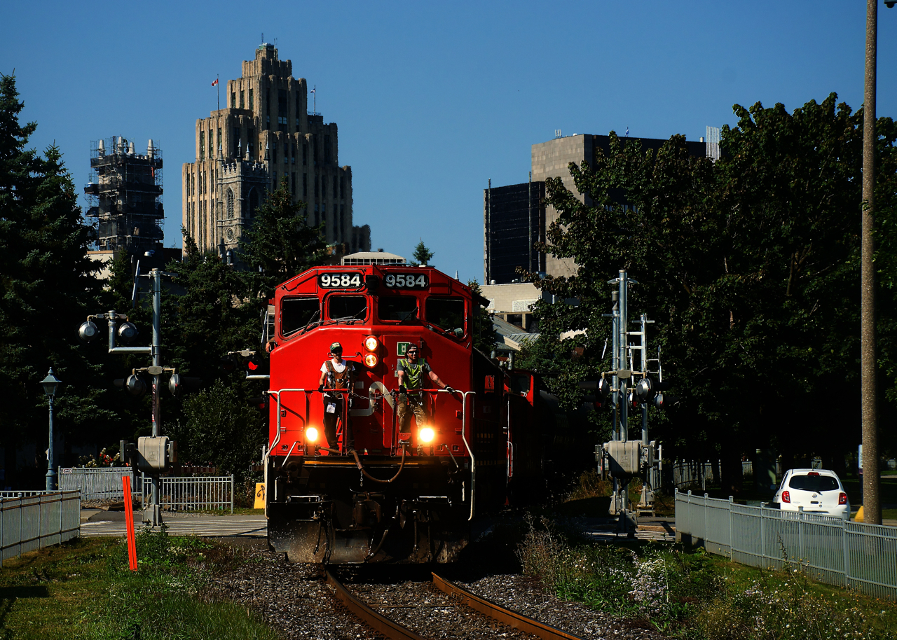 Crewmembers are out on the nose of CN 9584 as CN 500 leaves the Port of Montreal on a sunny Friday afternoon.