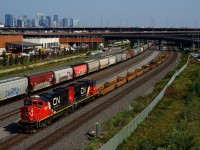 CN 500 has well cars for the Port of Montreal as it prepares to lift most of the grain cars that are seen at the left, which are also for the port.