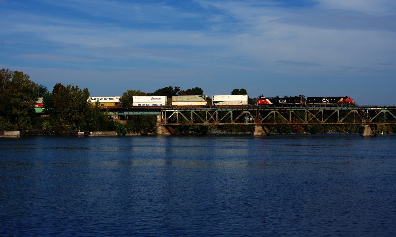 Toronto-Halifax train CN 120 starts its crossing of the Richelieu River with CN 2826 and CN 3305 up front.