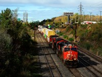 CN 120 is exiting Taschereau Yard with an ES44AC, an ET44AC and a Dash9-44CW up front.