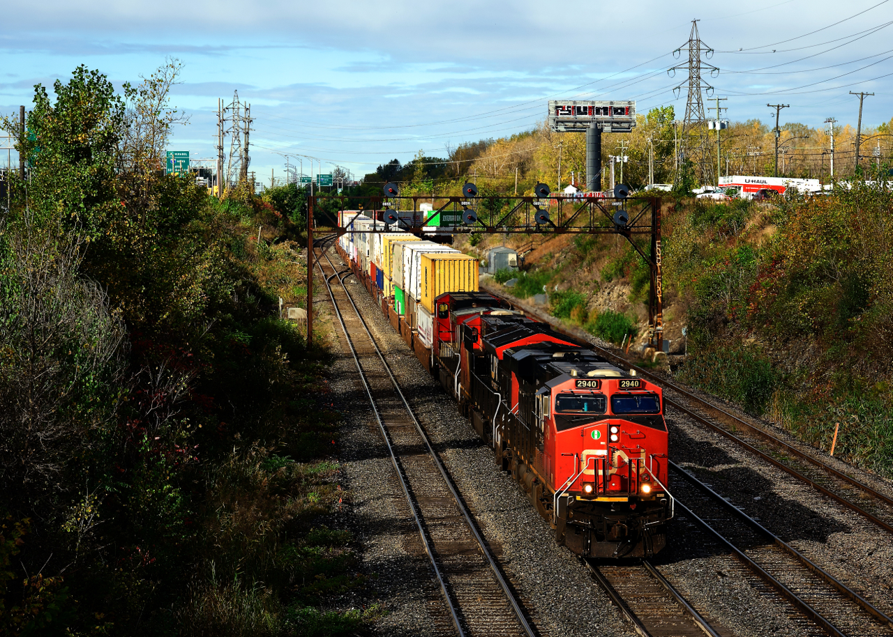 CN 120 is exiting Taschereau Yard with an ES44AC, an ET44AC and a Dash9-44CW up front.