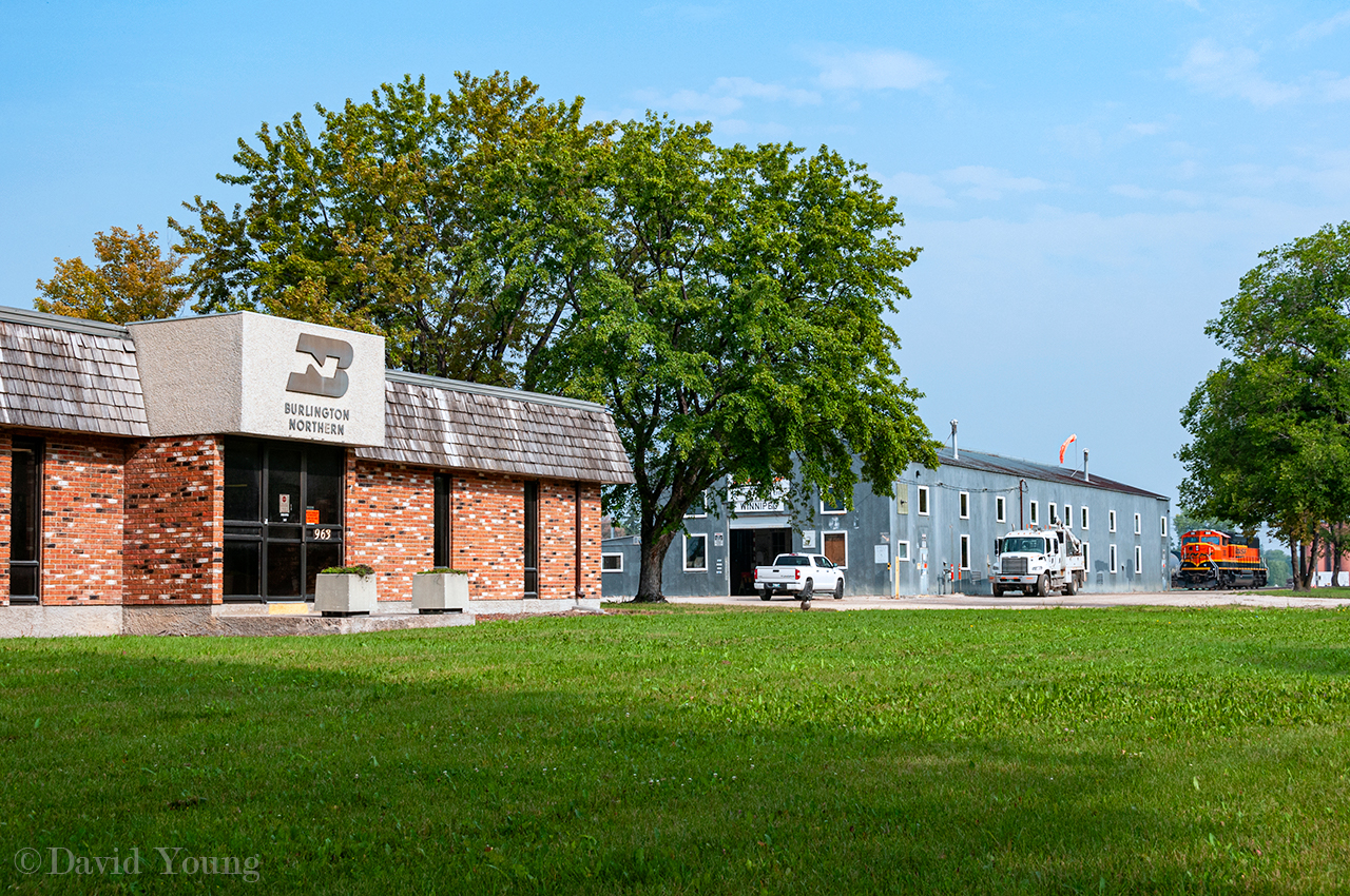 Vestiges of the BN. Burlington Northern insignia still adorns the yard office in Winnipeg at the corner of Taylor Ave and Lindsay Street. Looking beyond, an unusual visitor sits north of the shop in form of SD75i 292. Odd to see such a big unit in this neck of the woods as this operation is normally home to a single 4 axle engine.
