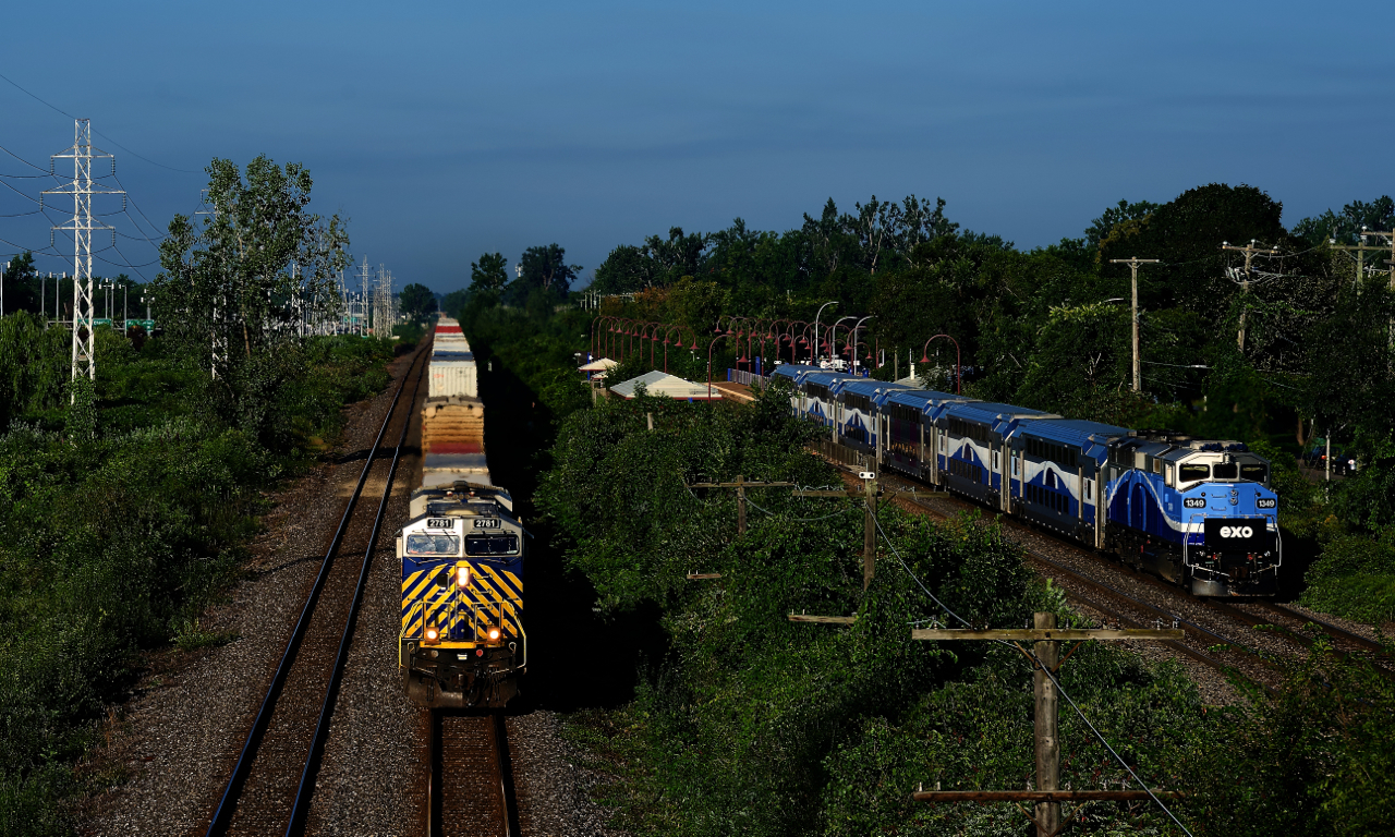 CN 108 is nearly finished its run from the West Coast as it passes through Pointe-Claire on CN's Kingston Sub. At right EXO 1349 pushes EXO 41 westwards on the parallel CPKC Vaudreuil Sub.