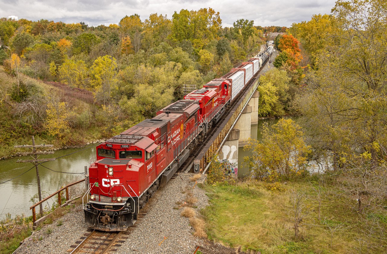 CPKC 135 with a pair of CP SD70ACU's, 7000 and 7003 heads south over the Thames River as it passes Coakley Siding in the town of Woodstock, Ontario.  I wasn't sure how long this train would take to work Wolverton, but thankfully it wasn't too long.  I heard him coming over the scanner and booked it towards the Vansittart Avenue bridge.  I am glad that I made it for this one - a pair of red ACU's complimenting the fall colors - with intact code lines, searchlights, and a bridge?  How could you go wrong?

October 15, 2023.