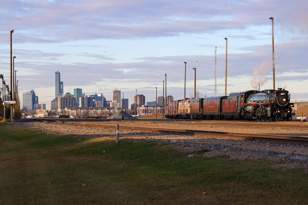 The Empress shoves into the South Edmonton Yard, with Edmonton's Skyline providing a beautiful backdrop as the sun sets on Alberta's Capital City.  The rails end about a mile north of here, by the old CPR South Edmonton Station, which has since been turned into a restaurant.  Known as Strathcona, its a bustling part of the city - however on the railroad side of things, the South Edmonton Yard only sees sporadic service from a local freight and much of the yard has been turned into a Lumber Transload facility.; CPKC's freight trains branch off just south of here towards Lambton Park and Clover Bar Yards.  

While South Edmonton is a shadow of its former self, it is not hard to imagine a CPR Passenger train blasting out of the South Edmonton Station, with the skyline in the background as they head south to Calgary.
