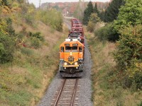 I finally got a shot at getting this BNSF 2090 leading from the Jones Baseline Bridge. It always seems to elude my short period of time I'm in Guelph to pick up my grandson. Today, I was in early and shot other locals and decided to head to the Watson Road crossing and wait a bit. GO 362 got a clearance through a foreman and then CN 540 got the same clearance a few minutes later so I took off for the Baseline bridge and waited it out. The giant Bell wire hanging on this side of the bridge is quite the obstacle so I had to kneel on the road to shoot under the railing and under the wire with cars, trucks and tractors driving by. But, it finally showed up with about 10 minutes to spare. BNSF 2090 heads west with a small string of empty lumber cars headed to the siding at Guelph Junction to wait out another GO.