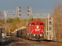 SD40-2F, CP 9014 with SD40-2 CP 6028 rumble their way up the grade as they head under the Twiss Road signal bank hauling a load of rails westward up the Galt sub. The former CMQ 9014 looks quite nice in its new CPKC red paint scheme but I think I would have preferred the old original blue and white a bit more. Running low on fuel, they decided to pull in to Puslinch siding to refuel but after the crew stopped to check the tanks, they decided to continue on to Wolverton where refueling would be easier. The sun came out as they rounded the bend with the still very dark skies in the background making the clean red stand out nicely.