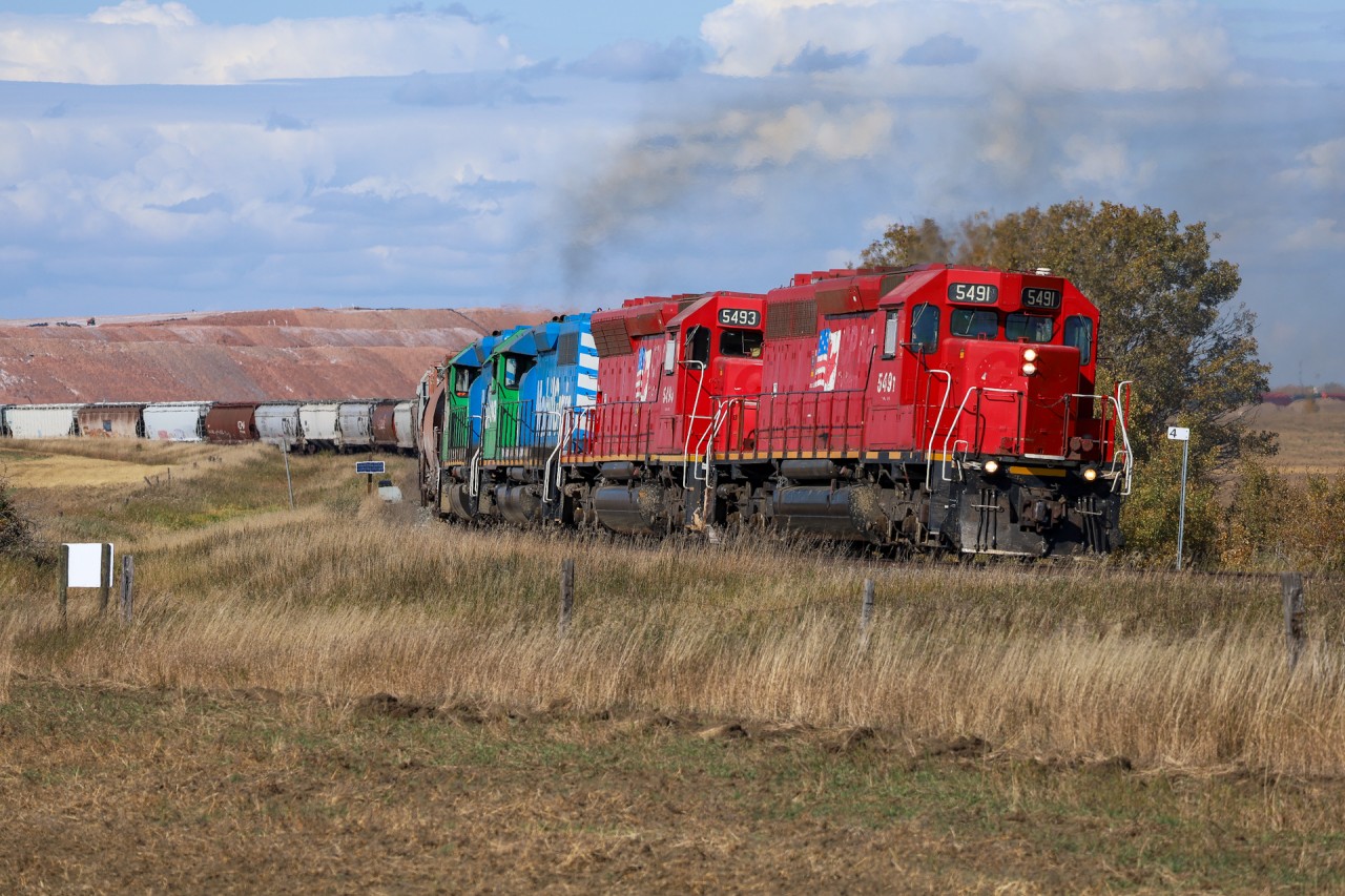 Big Sky Rail train 562 grinds upgrade towards Saskatoon, Saskatchewan at Mile 4 of CN's Rosetown Sub.  562 today had MGLX 5491, MGLX 5493, MGLX 3143, MGLX 6901.