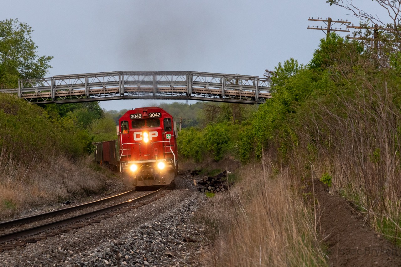 CP H88 climbs out of the Thames River valley west of Woodstock with 3 GP38-2s and 6200ft of traffic on the drawbar. Due to a derailment the week prior, H88 hadn't been able to run for 5 days. Traffic piled up and the crew was tasked to bring 103 cars back to London.