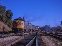 Toronto - London train 77 is seen crossing over from the south track of the Oakville Sub, taking the switch onto the north track of the Dundas at Bayview Junction.  77 has just backed out to Bayview after stopping at Hamilton's James Street station, where the three head end express boxcars <a href=https://www.railpictures.ca/?attachment_id=52960>seen earlier as it passed by</a> were setoff.<br><br><i>Scan and editing by Jacob Patterson.</i>