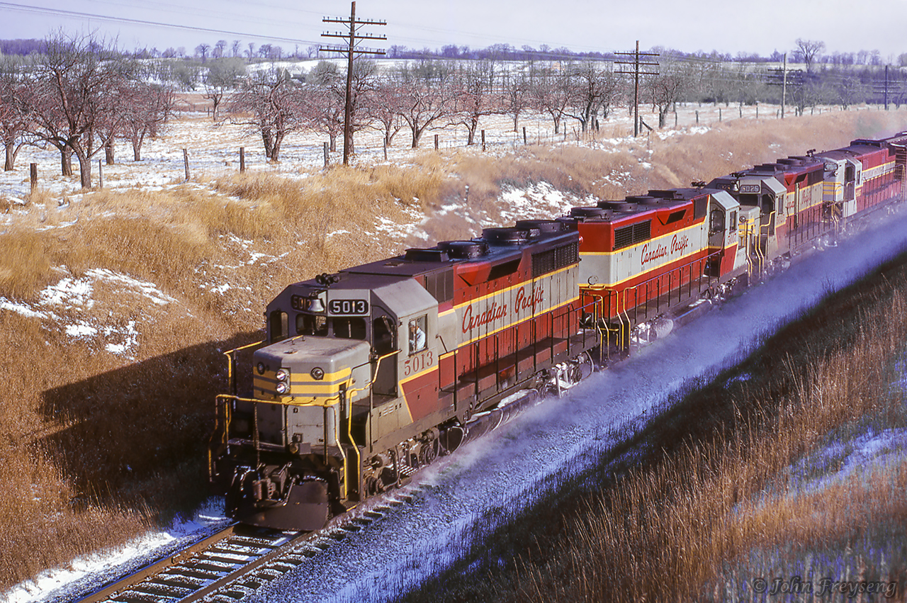 A westbound freight from Montreal behind three of Canadian Pacific's new GMD GP35s and a CLC H-24-66 passes beneath Newtonville Road.  All GMD products seen here are less than two years old, while the cLC unit has less than two years before meeting the torch in 1968.Scan and editing by Jacob Patterson.