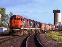 A westbound extra from Mac Yard to Capreol heads into the evening sun at Washago.<br><br><i>Scan and editing by Jacob Patterson.</i>