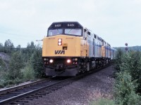 VIA #1, The Canadian, with the 6451 leading, approaches the Young Street crossing in Capreol, Ontario. The signal in the background was removed years ago.