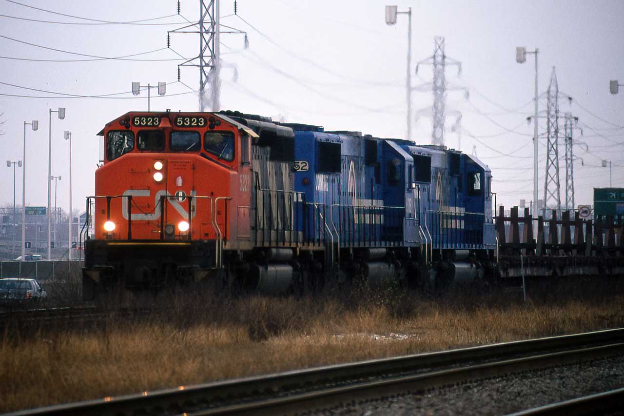 Montreal in December can be a little grey, but in the days when foreign power on CN was unheard of, 2 Conrail SD50's trailing a freight into Tachereau was a real treat. Alas, I did not have a weed-whacking stick handy.