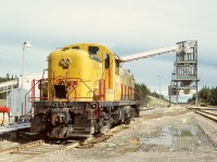 In Alberta’s foothills of the Rocky Mountains, natural gas extraction and related sulphur production became a significant industry.  One plant served by CN via the Brazeau sub. from near Red Deer and then the Ram River sub. had an ALCo (78939 of 1951-08) RS-3 ex Reading 524 as the plant switcher, shown here on Friday 1978-09-15 on its shoptrack conveniently near the sulphur loadout.
