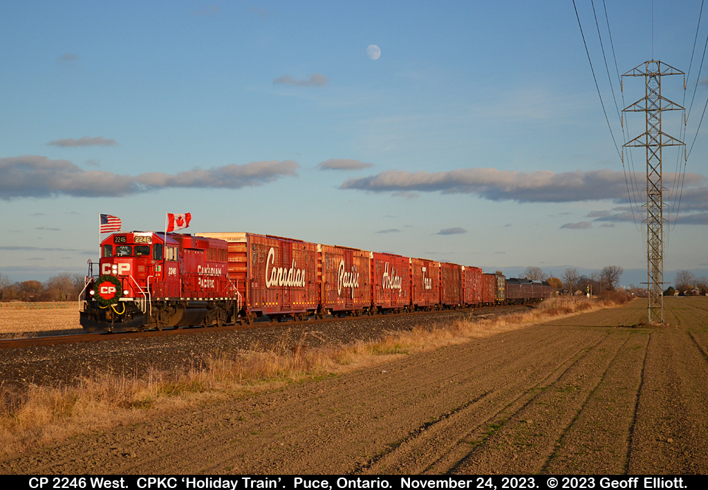 Is that a 'lunar' signal???  ;-)   With the moon in the sky, and the Canadian and U.S. flags flapping in the wind, the CPKC 2023 Holiday Train makes it's way west toward Windsor, Ontario in the late afternoon light of November 24, 2023.  As always CPKC put on a good show with the Holiday Train drawing observers and photographers all along the line to see what has become a welcome annual tradition.