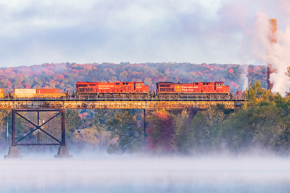 CP 8046 eases into Trenton for a meet with a westbound.  The sun has just risen allowing some nice light on the train and the hills but is not quite warm enough for the mist on the Trent River to burn off.