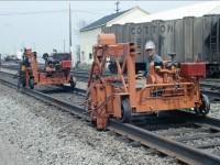 Here is the continuous welded rail gang installing the newly laid rail onto the ties at Bronte road just west of the original Bronte railway station in June of 1971. Taken from my fathers collection.