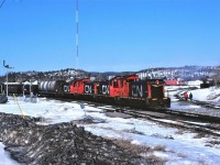 The ugly side of winter shows its true colours as the daily Sudbury Turn heads out of Capreol, Ontario on April 8th, 1982.  The railway made the museum remove the blades from train order mast as it "might confuse" operating crews.  The railway would not accept both blades displaying clear or green.  Four SW1200RS units (1372 1375 1373 and 1376 this day) were standard power for the job in 1982.