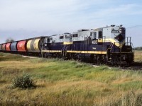 A colourful 30 plus hoppers trails 584 on this September morning. The front few cars will shortly find themselves spotted at the Redwater elevators. By 11:30, the units will be back on the train and making for Radway, the next stop of the day.