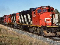 With the 4290 and 4345 helping out, this unit train brings home 35 loads. 50 loads requires 3 GP38's or more than 3 old timers. 50 sulphur cars really has three 38's working on the Redwater hill. In this photo the train has rounded the corner at mile 23.8 and will soon be going past the hamlet of Coronado. Time was 18:30, cab 79772 on the end.