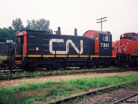 CN 421 is viewed waiting at the Kitchener yard for the 15:30 Kitchener Job to return from the Huron Park Spur with their lift of newly built frames from the Budd Plant. 421's consist included; 9560, 9620, 9490 and 7311.  SW1200RSm 7311 was likely heading to London for work in the yard.  