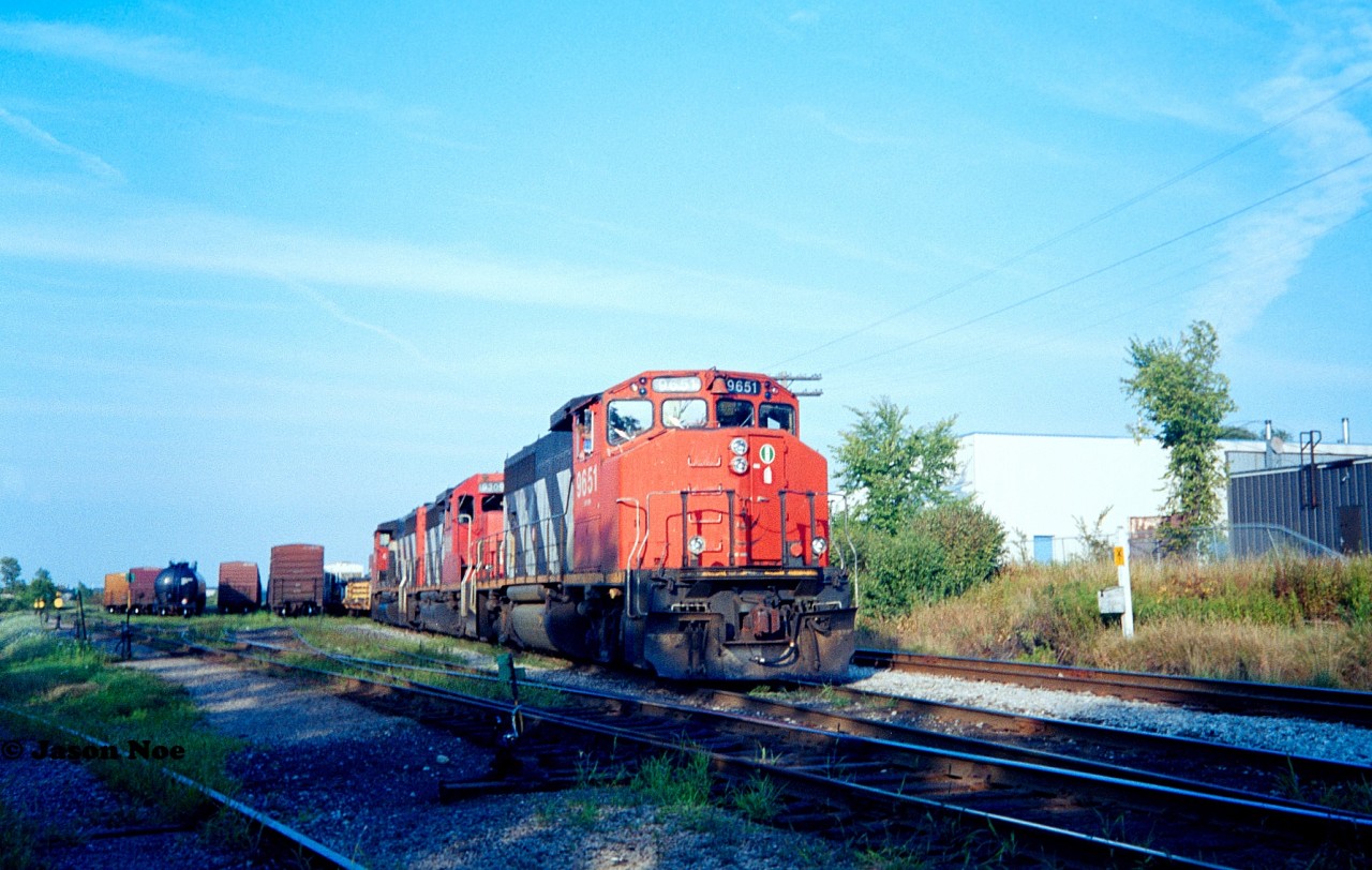 On a summer evening, CN 421 pauses in the siding at Kitchener seen in the yard with 9651, 9309 and 9589.