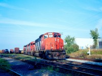 On a summer evening, CN 421 pauses in the siding at Kitchener seen in the yard with 9651, 9309 and 9589.
